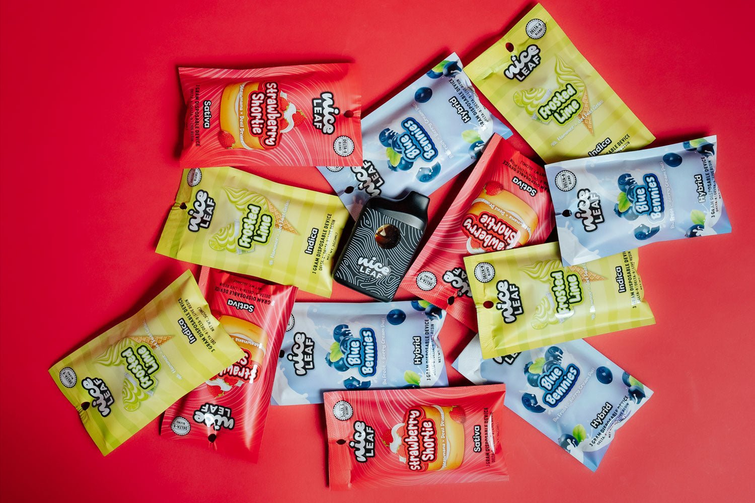 all three delta 8 vape pens piled on a red background