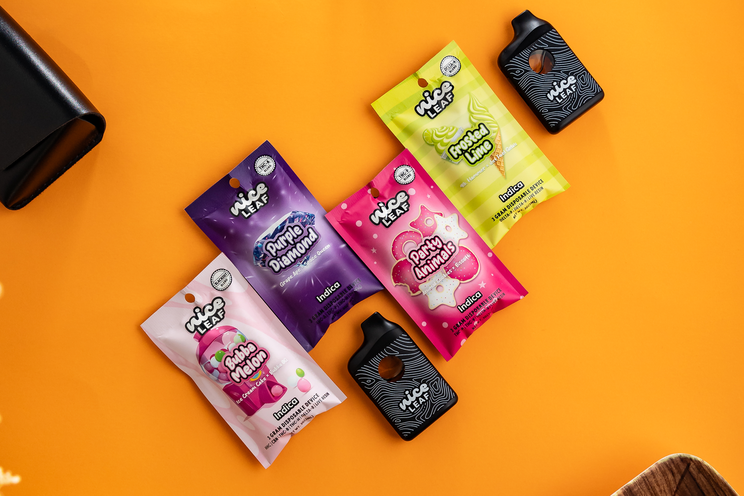 assorted nice leaf vape pens displayed on an orange table