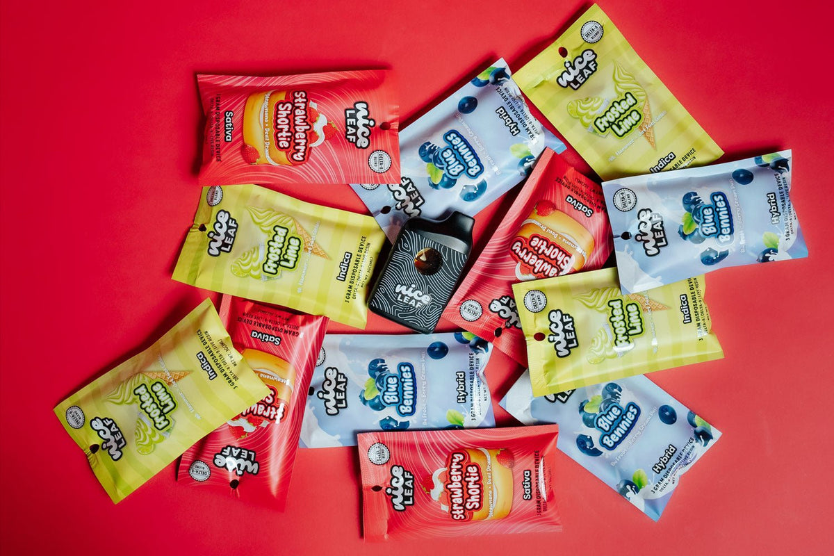 all three delta 8 vape pens piled on a red background